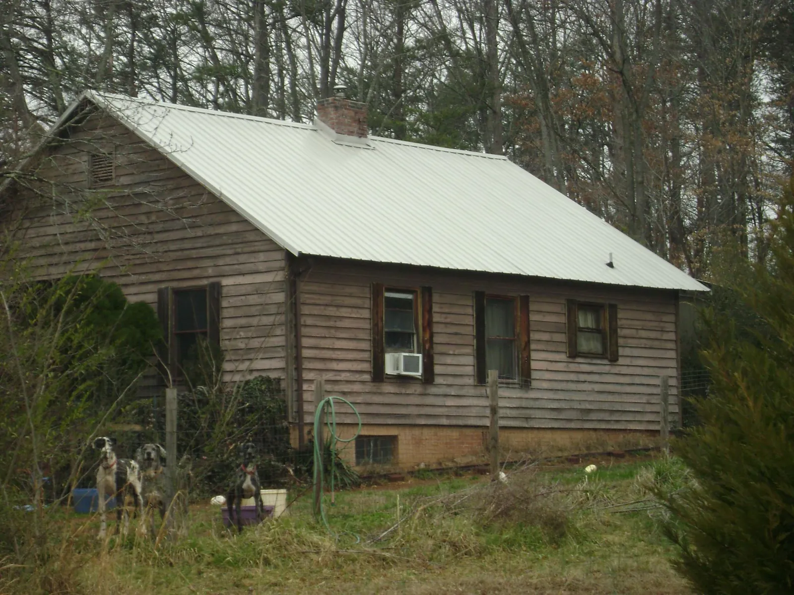 White metal roof on an old wood sided farmhouse, from a Metal Roof Installation job in Ringgold